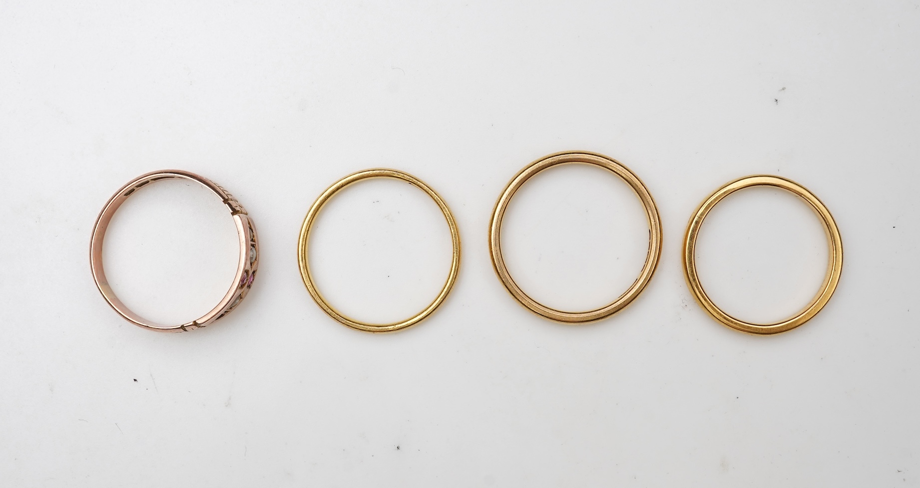 A collection of four gold rings